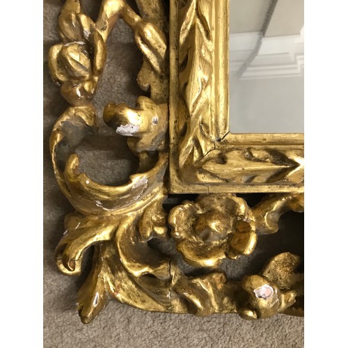 1145A - A 19thC ornate gilt wood framed mirror with replacement back. Frame 107 x 90cm.