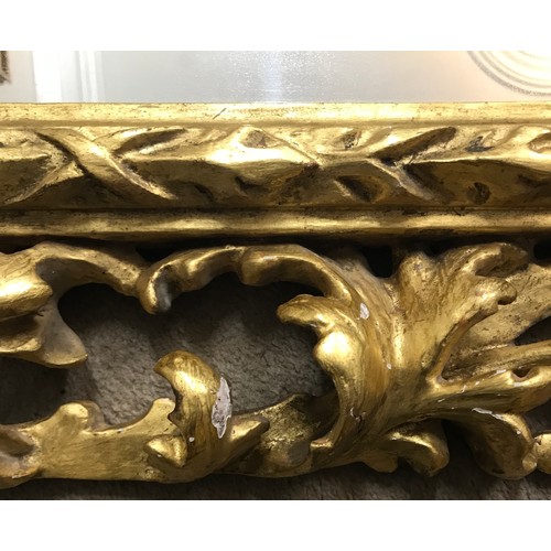 1145A - A 19thC ornate gilt wood framed mirror with replacement back. Frame 107 x 90cm.