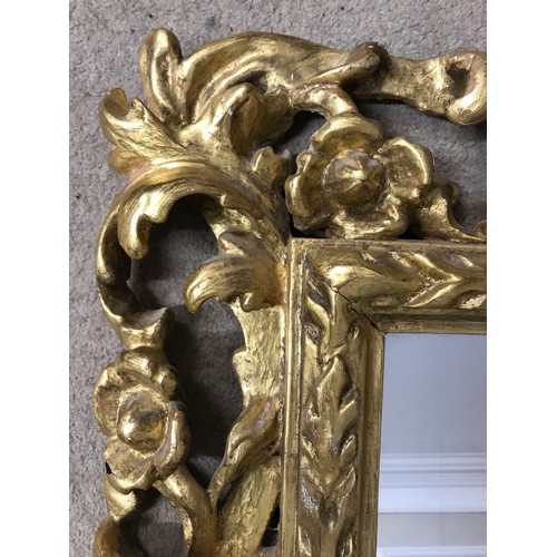 1145A - A 19thC ornate gilt wood framed mirror with replacement back. Frame 107 x 90cm.