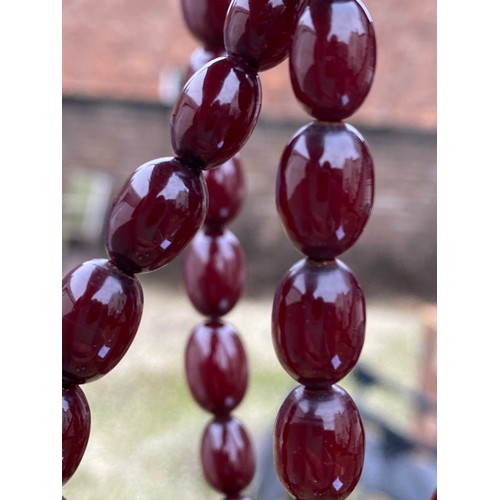 610 - Cherry amber bead necklace. Weight 64gm.