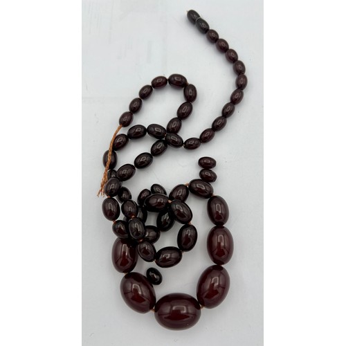 610 - Cherry amber bead necklace. Weight 64gm.