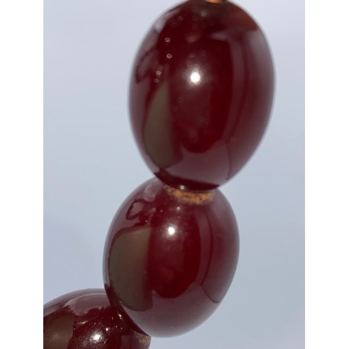 610 - Cherry amber bead necklace. Weight 64gm.