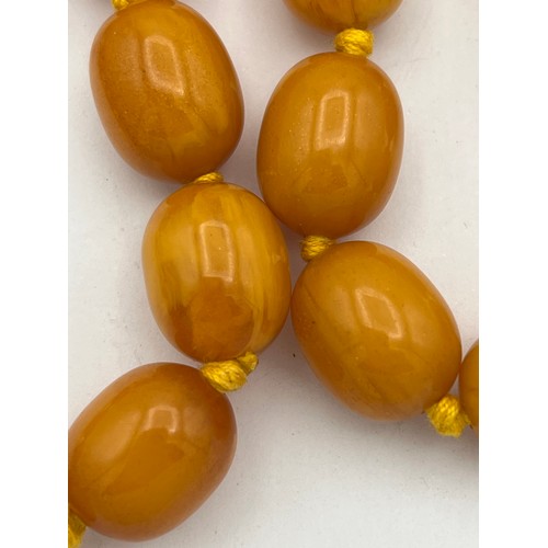 541 - Two string of butterscotch amber beads, approx length 80 & 52cm. 213.9gm.