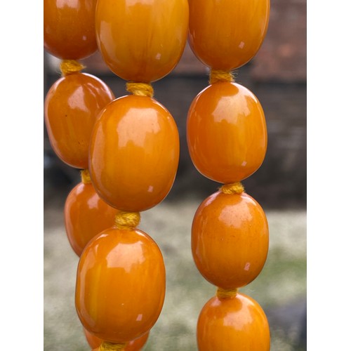 541 - Two string of butterscotch amber beads, approx length 80 & 52cm. 213.9gm.