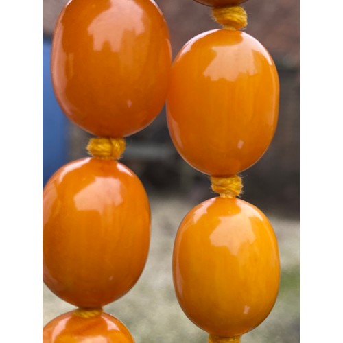 541 - Two string of butterscotch amber beads, approx length 80 & 52cm. 213.9gm.