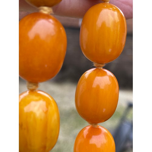 541 - Two string of butterscotch amber beads, approx length 80 & 52cm. 213.9gm.