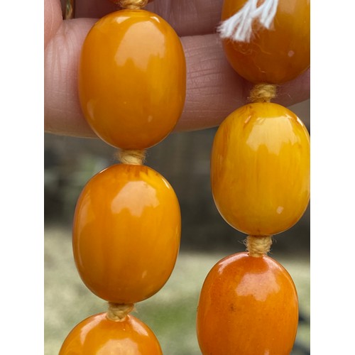 541 - Two string of butterscotch amber beads, approx length 80 & 52cm. 213.9gm.