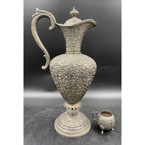 690 - Heavily decorated white metal ewer and small mug, possibly Indian 19thC Indian Kutch silver ? 35cm h...