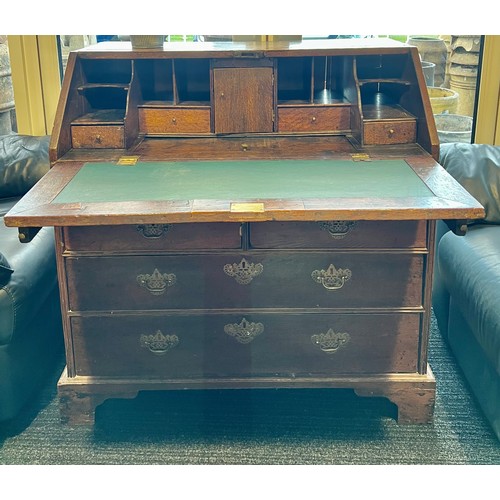 180A - A 18thC oak bureau on bracket feet with fitted interior and lidded compartment. 104 h x 59 d x 97cm ... 