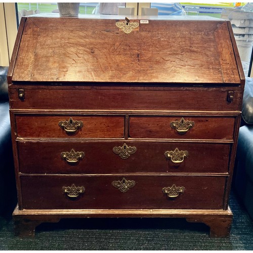 180A - A 18thC oak bureau on bracket feet with fitted interior and lidded compartment. 104 h x 59 d x 97cm ... 