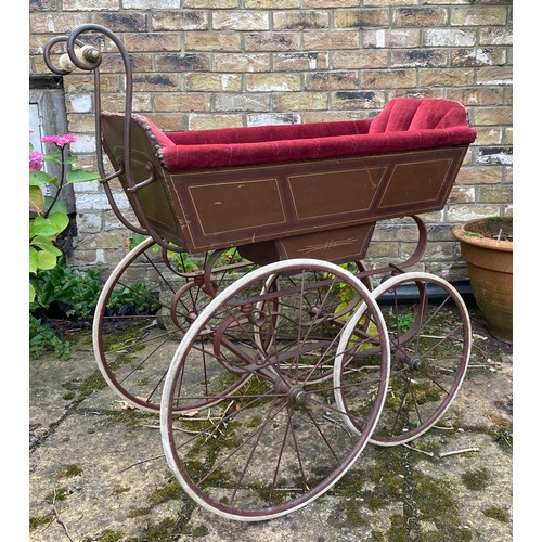 1103 - A 19thC wood and iron pram with ceramic handle with recently upholstered interior. 93 l x 48cm w.