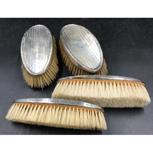 734 - Two pairs of identical men's grooming brushes with silver tops, Birmingham 1924 Williams Adams, 417g... 