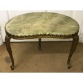 A gilt metal side table with green onyx shaped top measuring 40h x 47w x 28cm d