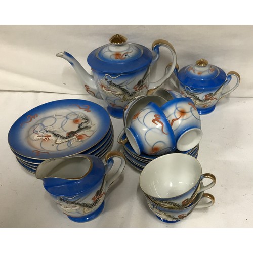 241 - A Japanese Moriage Geisha Lady Lithophane blue tea set decorated in dragons to include 6x cup and sa... 