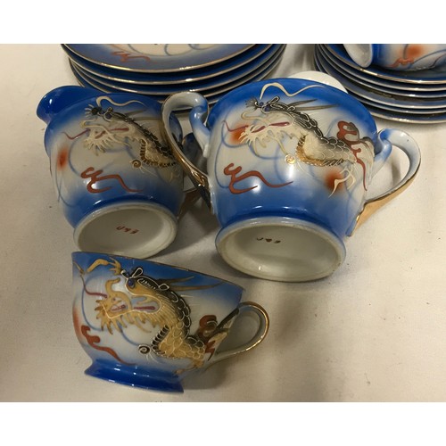 241 - A Japanese Moriage Geisha Lady Lithophane blue tea set decorated in dragons to include 6x cup and sa... 