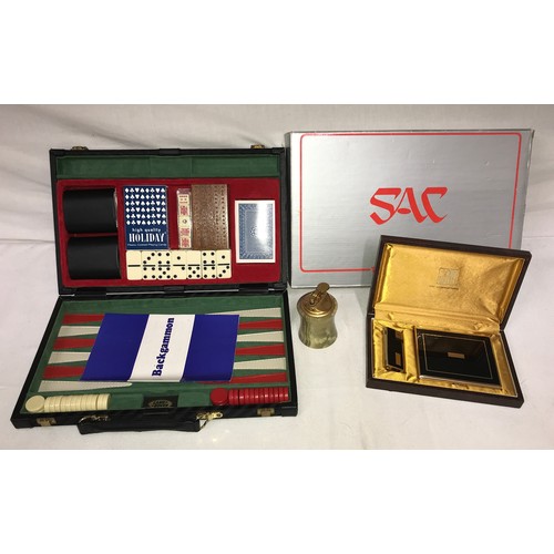 1099 - A leather case containing a backgammon game, along with an onyx table lighter and a boxed set of a c... 