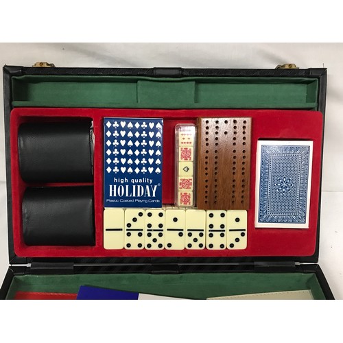 1099 - A leather case containing a backgammon game, along with an onyx table lighter and a boxed set of a c... 