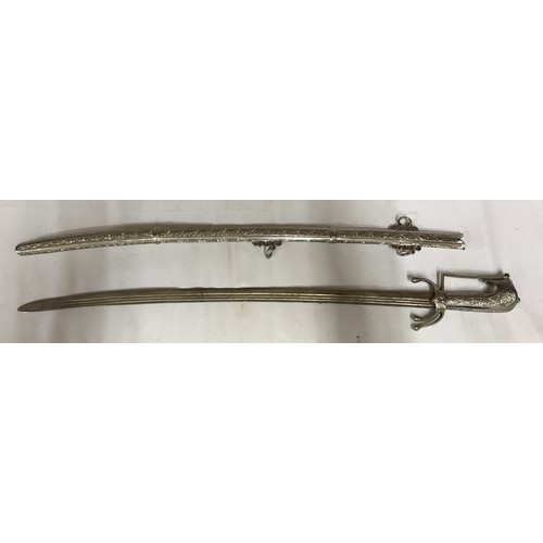 1101 - A white metal sword with decorative hilt and scabbard (Tulwar ?) together with a short white metal s... 