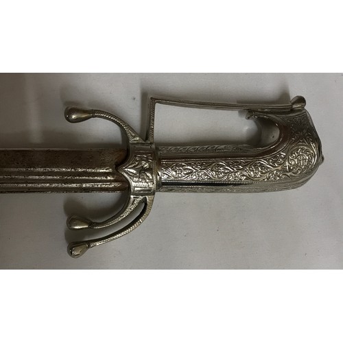 1101 - A white metal sword with decorative hilt and scabbard (Tulwar ?) together with a short white metal s... 