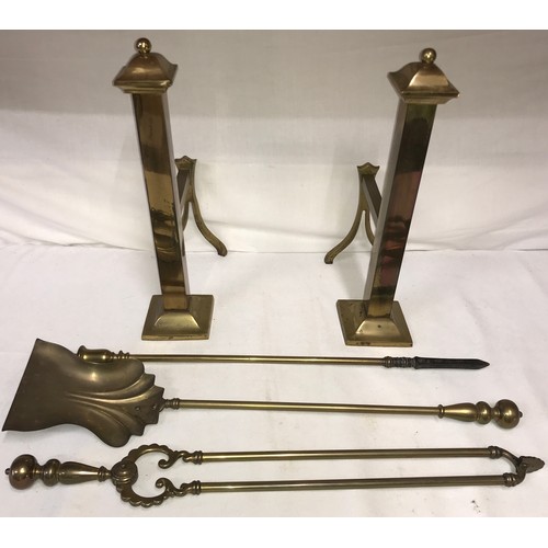 814 - A pair of brass fire dogs and associated irons.