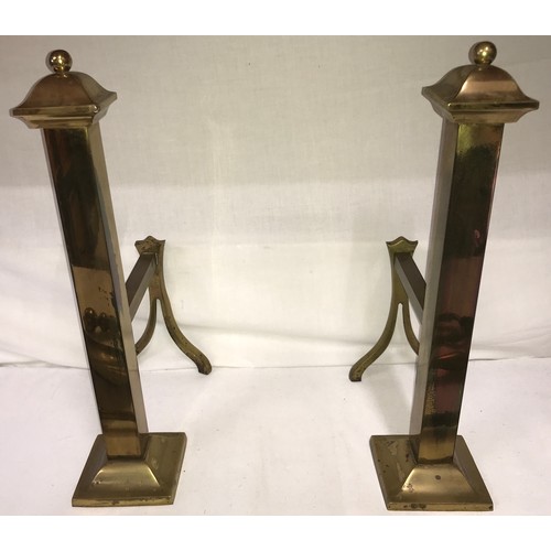 814 - A pair of brass fire dogs and associated irons.