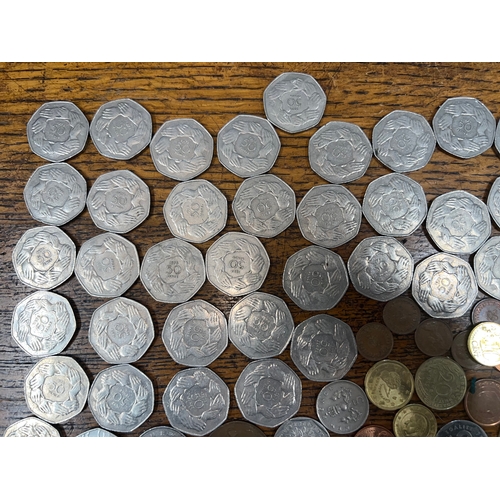 784 - A collection of coins to include mainly 1973 50p's, sixpences, Francs, Cents, etc.