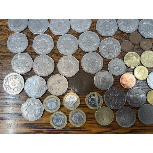 784 - A collection of coins to include mainly 1973 50p's, sixpences, Francs, Cents, etc.