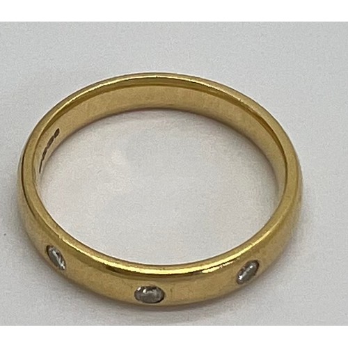 411 - An 18 carat diamond set gold wedding band. Weight 4.9gm. Size P. Marked 750.