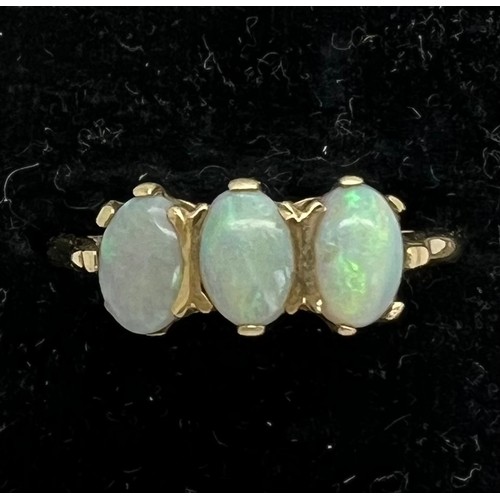 413 - A three stone opal ring set in 9ct gold. Total weight 
2.2gm. Size P.