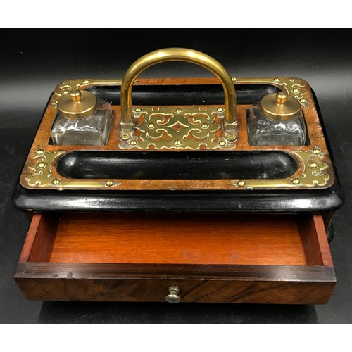 1089 - A rectangular wooden ink stand with two detachable glass inkwells, central brass carrying handle and... 