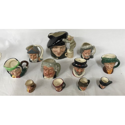 246 - A collection of 11 toby jugs of various size largest Tam o'Shanter along with three figurines, two o... 