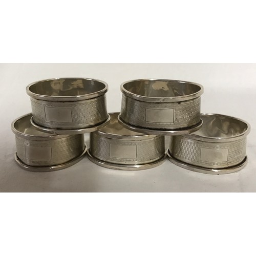 726 - Eight silver napkin rings total weight 100gms Birmingham 1932, 5 matching and 3 individual.