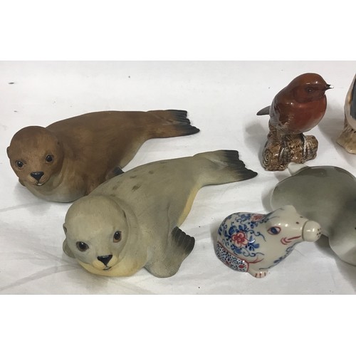 248 - A collection of ceramic animals to include two Beswick birds 2413 Nuthatch and 980 Robin, three Ayns... 