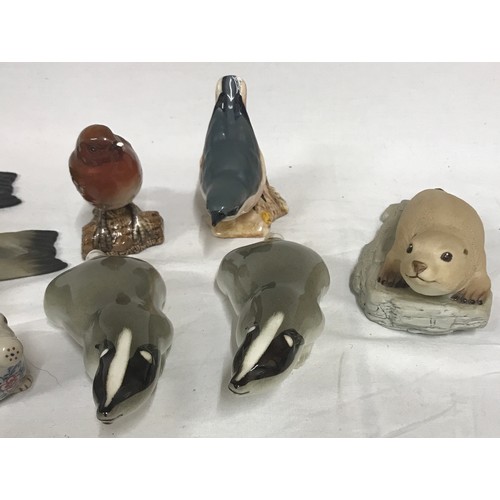 248 - A collection of ceramic animals to include two Beswick birds 2413 Nuthatch and 980 Robin, three Ayns... 