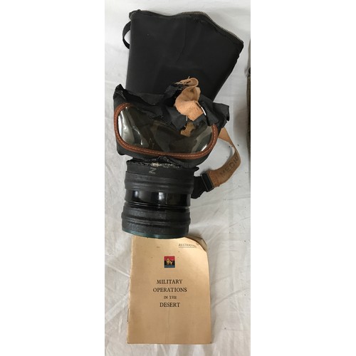 1094 - Two vintage gas masks both with fitted bags one with a Military operations in the desert booklet.