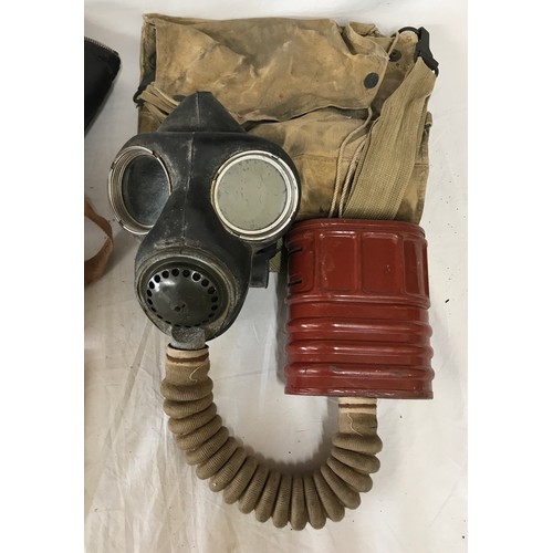 1094 - Two vintage gas masks both with fitted bags one with a Military operations in the desert booklet.