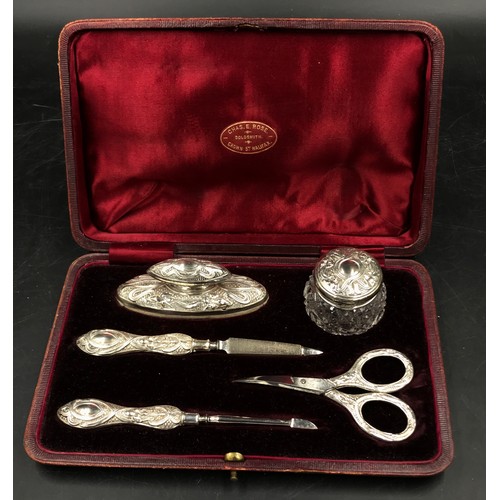 741 - A hallmarked silver mounted five piece vanity set with Art Nouveau and iris decoration, Birmingham 1... 