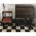 A child sized early 20thC roll top desk and chair.
Desk 77 h x 52 w x 36cm d. Chair 55 h x 32cm w.