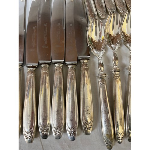 692 - An extensive suite of German silver cutlery. Marked with German marks and Posen .800. Initialled E. ... 