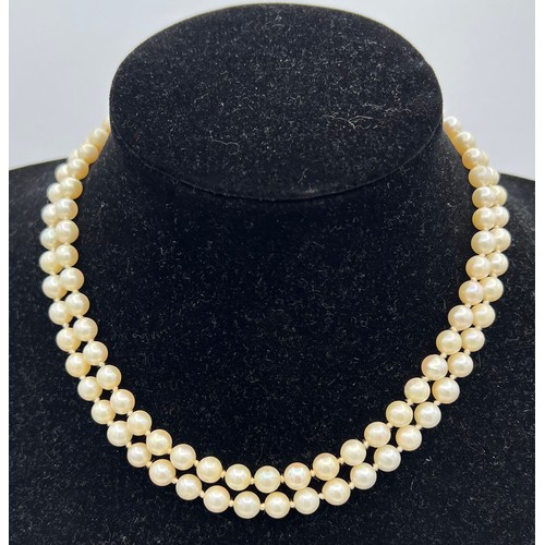 450 - A double strand cultured pearl necklace with silver clasp together with a long cultured pearl neckla... 