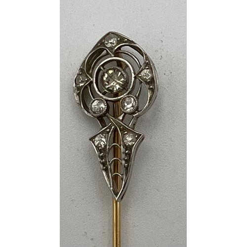 454 - A yellow and white metal pin set with diamonds. 7cm long. Weight 2.2gm.