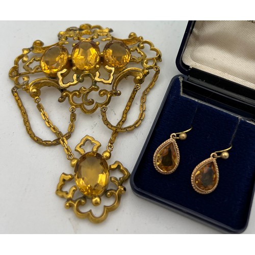 456 - A 19thC brooch set with citrines in yellow metal together with a pair of citrine 
 9ct gold earrings... 