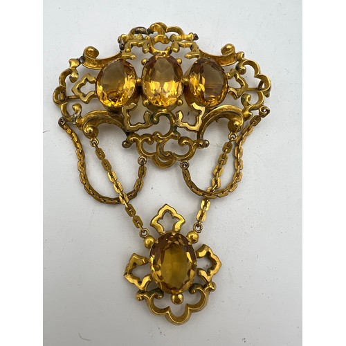 456 - A 19thC brooch set with citrines in yellow metal together with a pair of citrine 
 9ct gold earrings... 