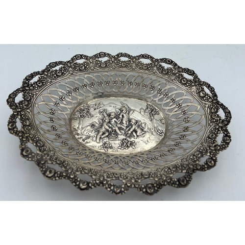 705 - German silver oval dish depicting cherubs at play with pierced border. Size 20.5 x 14.5cm.  Weight 1... 