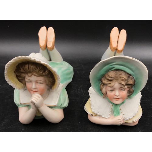 182 - A pair of early 20thC bisque piano dolls along with a Paragon figurine 