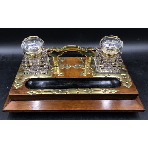 1002 - A Victorian brass-mounted macassar ebony desk folder along with a brass-mounted desktop ink stand.