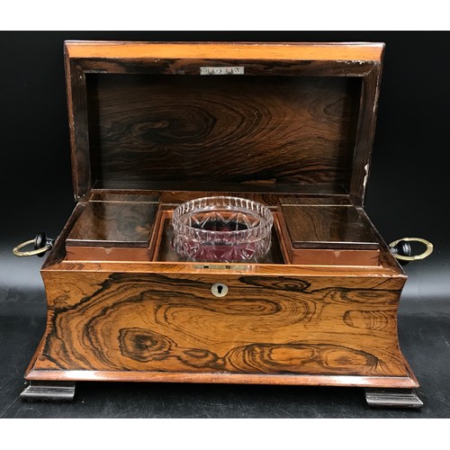 792 - A rosewood tea caddy with a hinged lid, two ring handles, key and working lock, mother of pearl escu... 