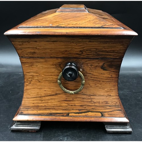 792 - A rosewood tea caddy with a hinged lid, two ring handles, key and working lock, mother of pearl escu... 