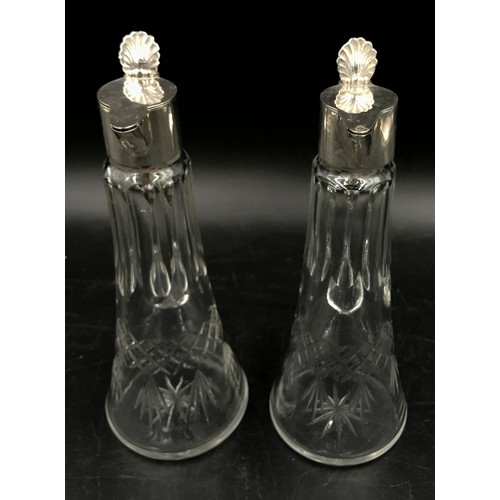 697 - A matching pair of cut glass silver topped whiskey noggins marked 925 under lid 18cm h.