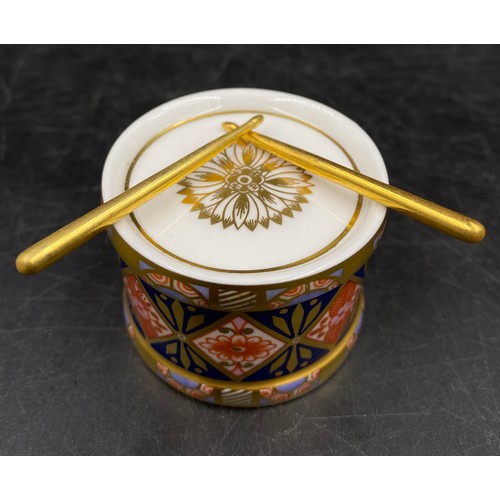 167 - A group of Royal Crown Derby porcelain miniature items, comprising toy drum with drumsticks, champag... 